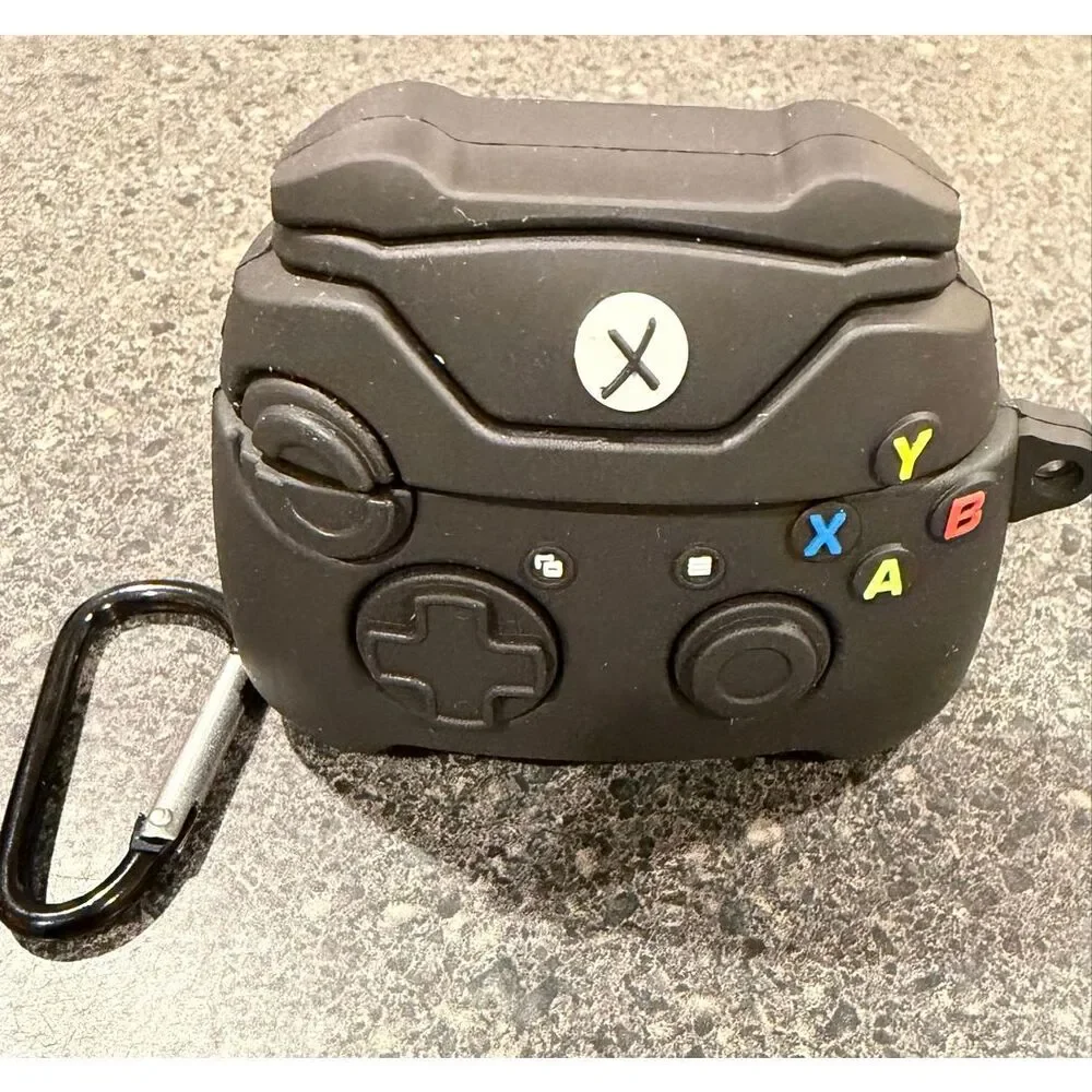 Silicone protective case for Apple AirPods, designed to resemble a black Xbox co